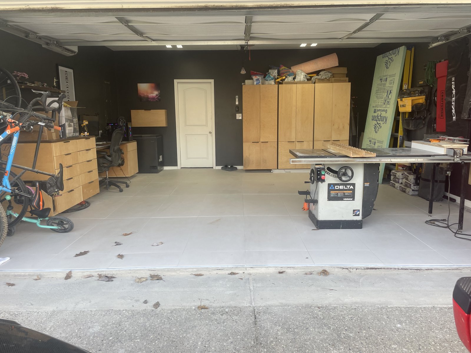 Custom maple plywood garage storage cabinetry in a home workshop